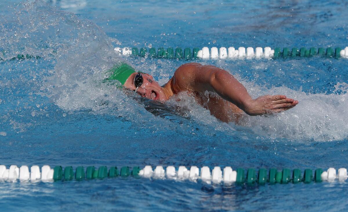 Costa Mesa's Aidan Blair competes in the 100-yard freestyle during an Orange Coast League meet against Estancia on April 3, 2019.