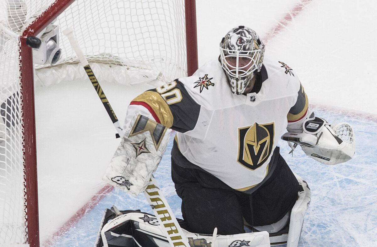 The puck hits the post as Vegas Golden Knights goaltender Robin Lehner watches during the first period of Game 3 of the team's NHL hockey Western Conference final against the Dallas Stars, Thursday, Sept. 10, 2020, in Edmonton, Alberta. (Jason Franson/The Canadian Press via AP)