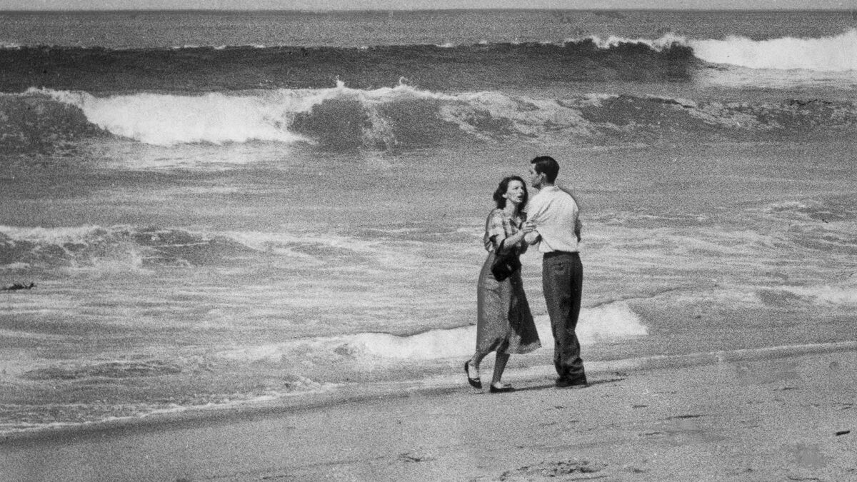 April 2, 1954: A couple are photographed moments after learning that their 19-month-old child had been swept out to sea at Hermosa Beach.