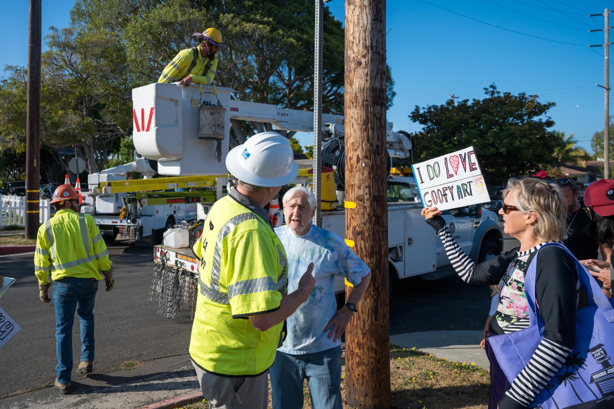 People gather around a pole.