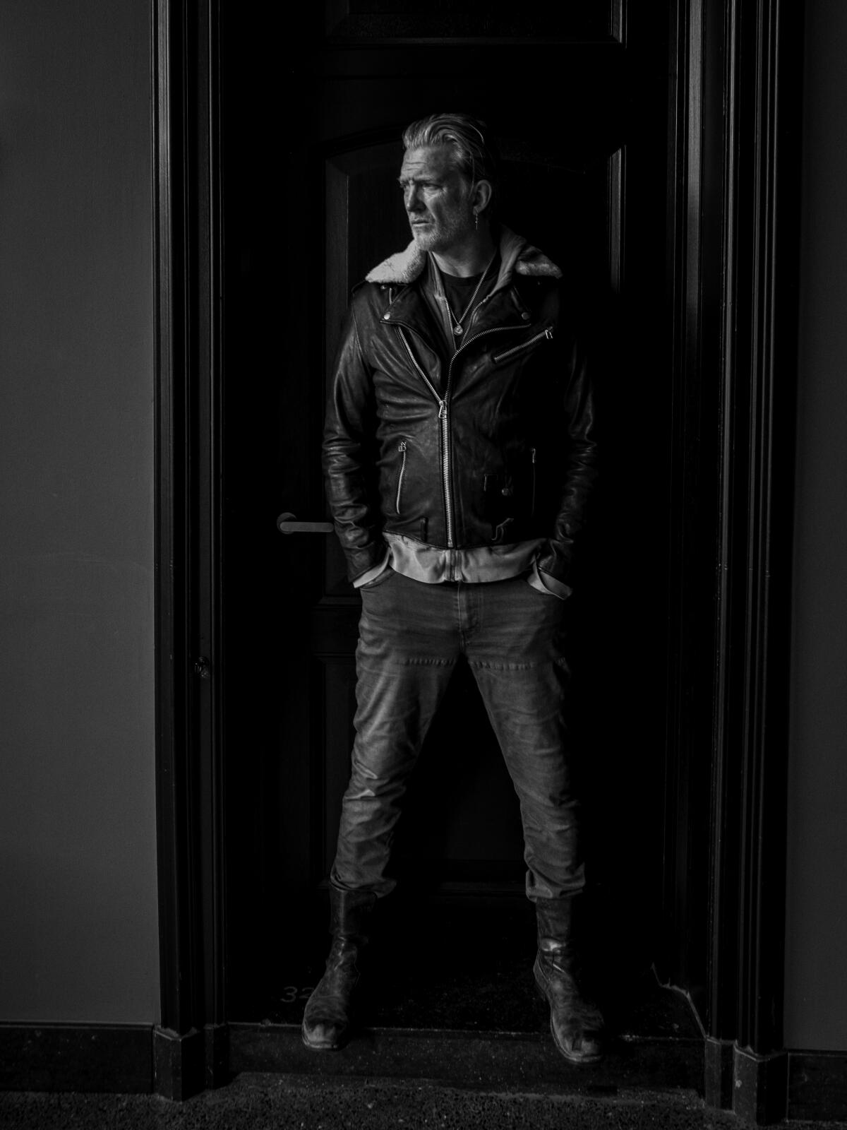 Josh Homme standing in a doorway