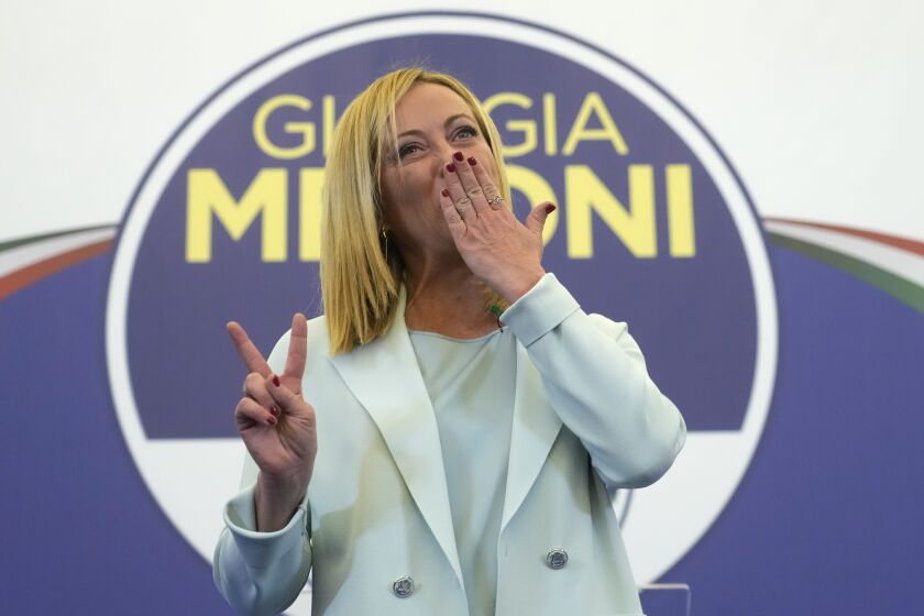 Far-Right party Brothers of Italy's leader Giorgia Meloni flashes the victory sign at her party's electoral headquarters in Rome, early Monday, Sept. 26, 2022. Italian voters rewarded Giorgia Meloni's euroskeptic party with neo-fascist roots, propelling the country toward what likely would be its first far-right-led government since World War II, based on partial results Monday from the election for Parliament. (AP Photo/Gregorio Borgia)