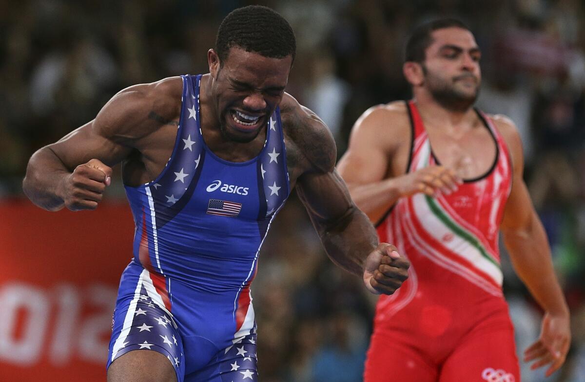 American Jordan Burroughs celebrates after defeating Iran's Sadegh Saeed to win the gold medal in the men's freestyle 163-pound division at the 2012 London Olympics.