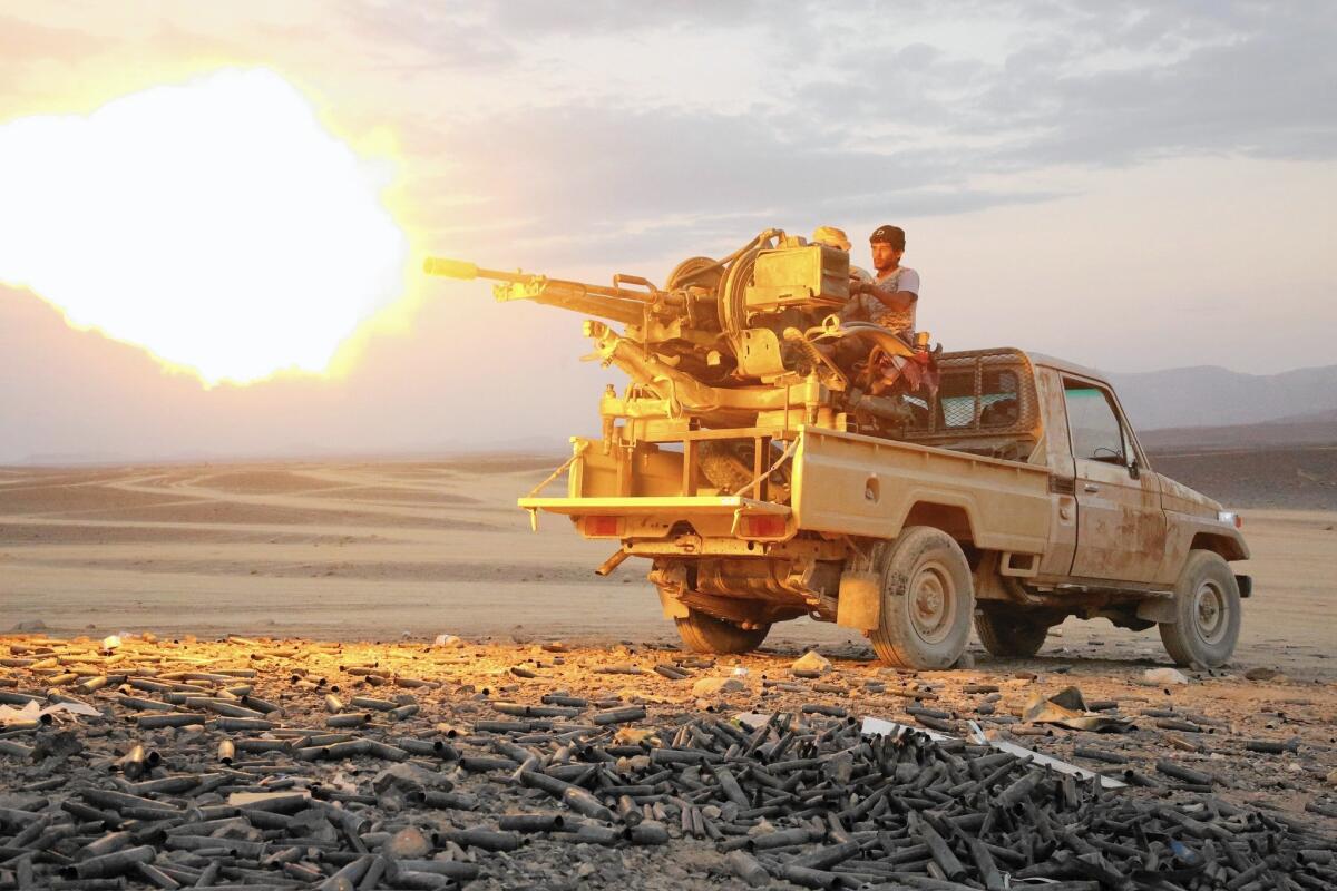A member of the pro-government forces battling Houthi rebels unleashes machine-gun fire in Sirwah, Yemen.