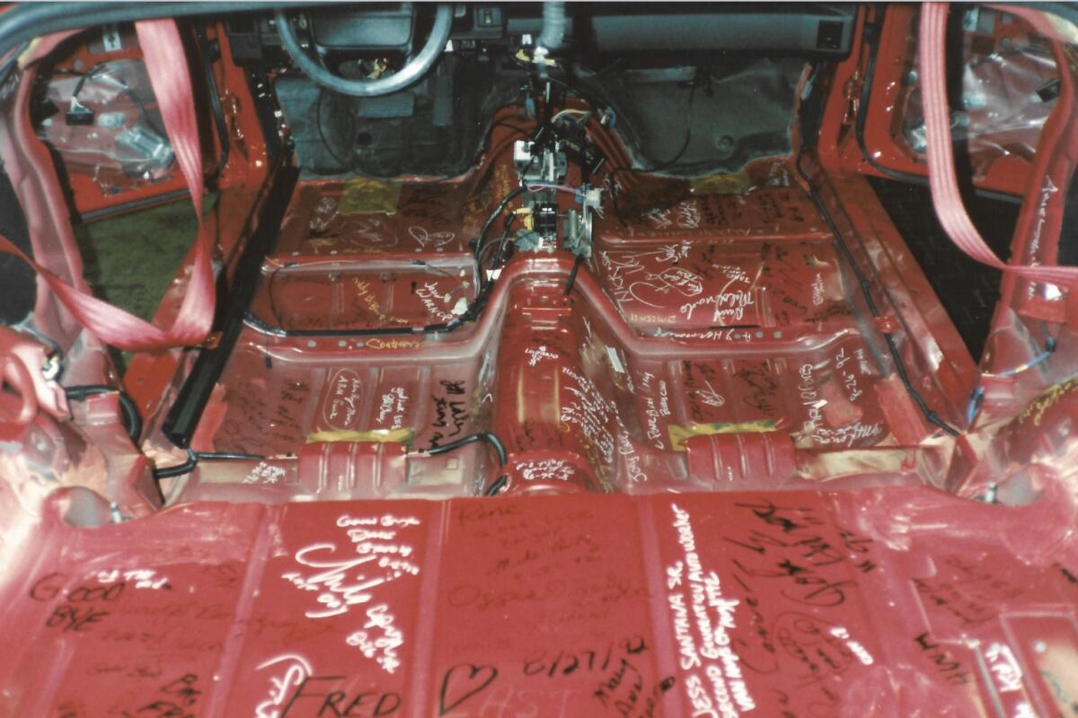 Signatures on the red engine of a car