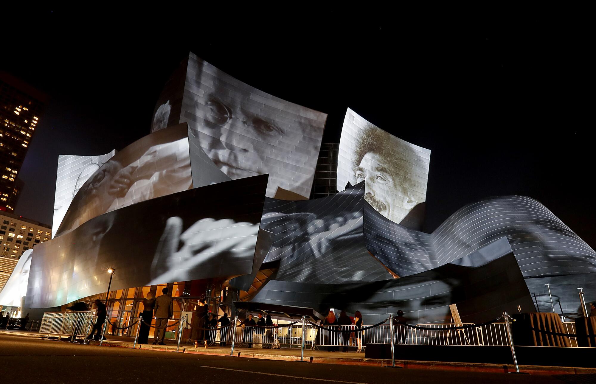 Giant faces are projected onto the exterior of Disney Hall for the L.A. Phil's centennial in 2018.