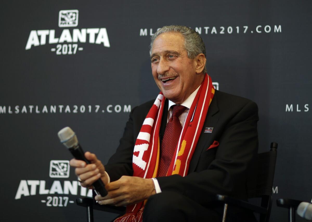 Arthur Blank, owner of the Atlanta Falcons, smiles during a news conference Wednesday to announce that Atlanta will receive a Major League Soccer franchise. Blank will be the new team's owner.