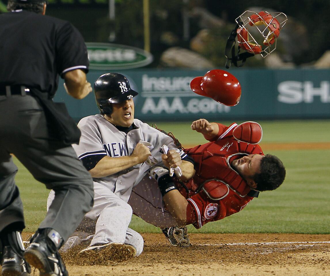 Yankees' Mark Teixeira collides with Angels catcher Bobby Wilson at Angel Stadium.