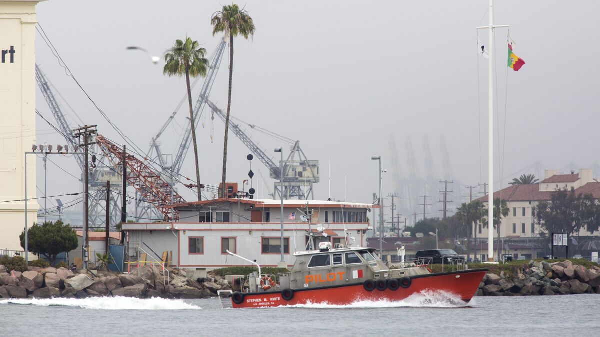Pilot Service vessel Stephen M. White and crew pass their headquarters building to guide an incoming ship to dock.