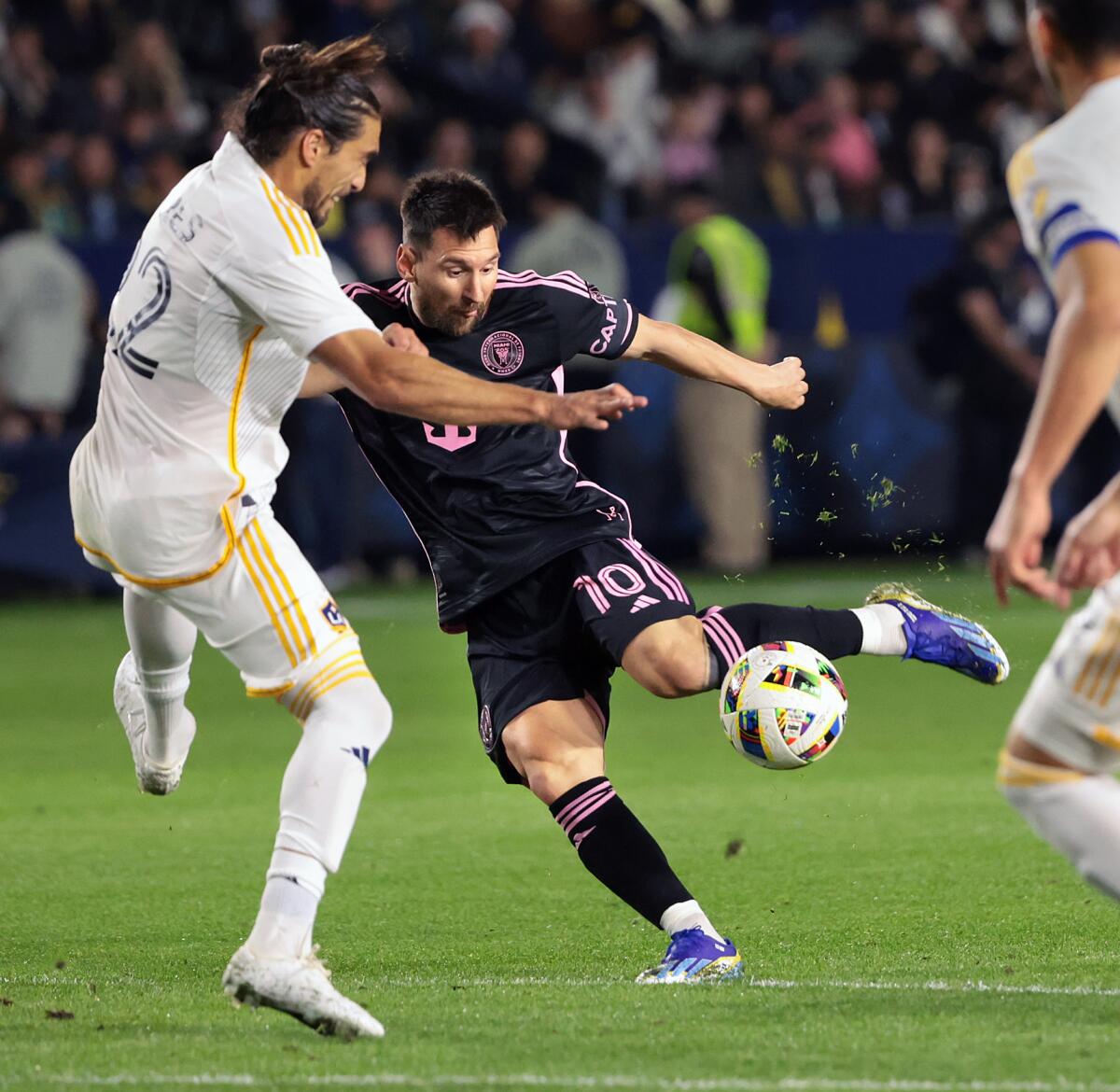 Inter Miami's Lionel Messi takes a shot on goal in front of Galaxy defender Martin Caceres during the first half Sunday.