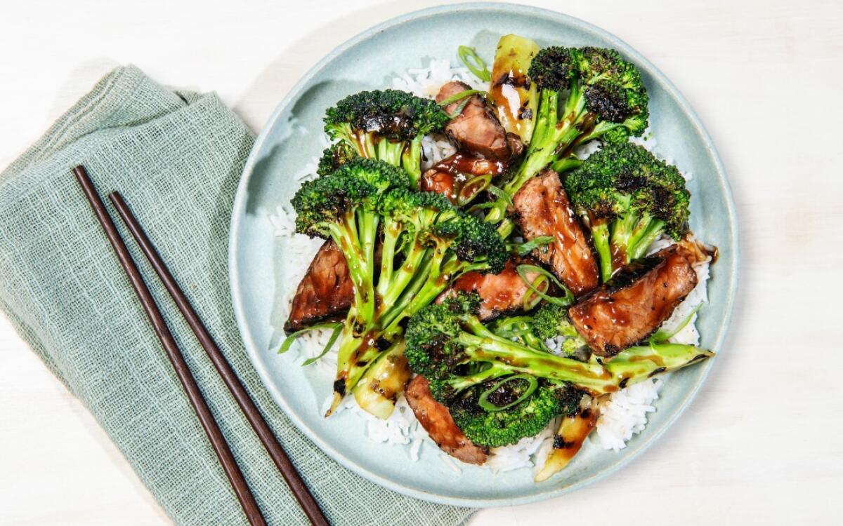 A plate of Grilled Beef and Broccoli over white rice