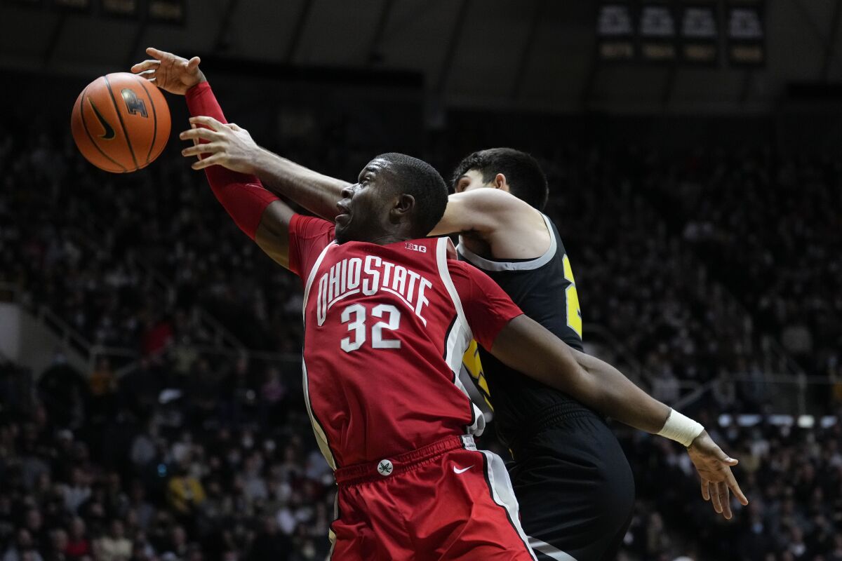 Ohio State forward E.J. Liddell, left, fights for a rebound with Purdue guard Ethan Morton (25) in the first half of an NCAA college basketball game in West Lafayette, Ind., Sunday, Jan. 30, 2022. (AP Photo/AJ Mast)