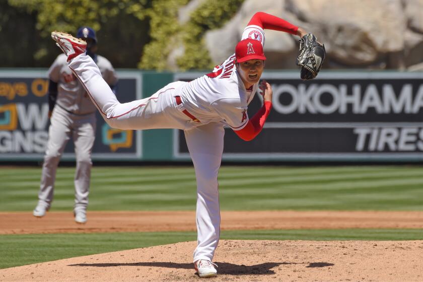 Los Angeles Angels pitcher Shohei Ohtani, right, of Japan, follows through as Houston Astros' Yuli Gurriel.