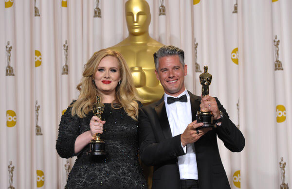 Adele and Paul Epworth pose with their award for best original song for "Skyfall" during the Oscars.
