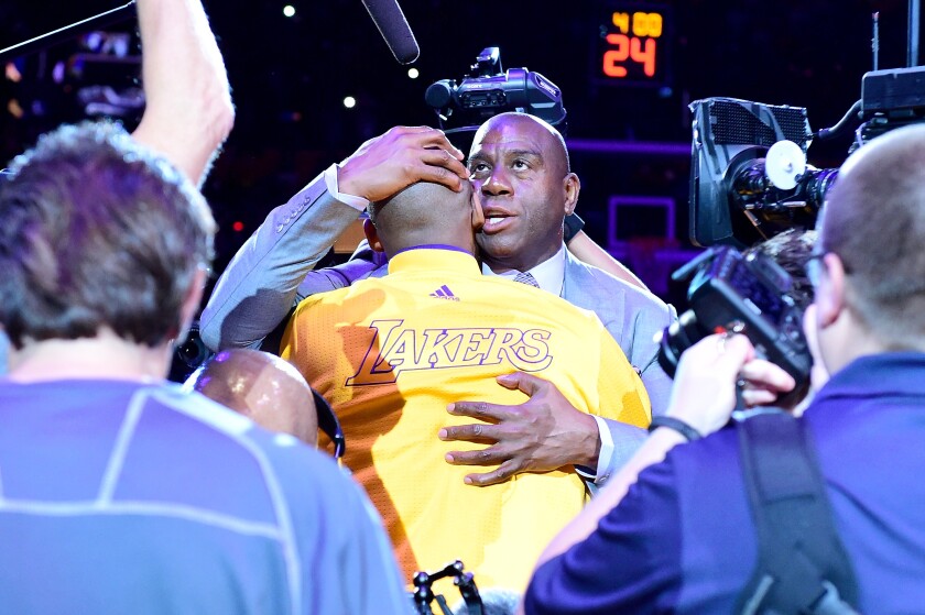 Magic Johnson hugs Kobe Bryant before Bryant's final game, against the Utah Jazz at Staples Center, on April 13, 2016.