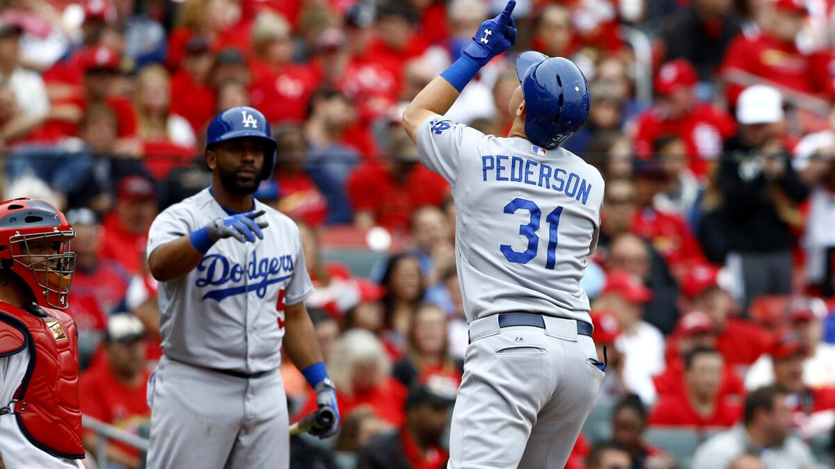Dodgers center fielder Joc Pederson celebrates along with teammate Alberto Callaspo after hitting a solo home run against the Cardinals in the eighth inning Sunday in St. Louis.