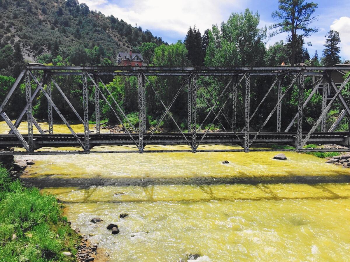 Contaminated water from an old gold mine flows through the Animas River in Durango, Colo. The Environmental Protection Agency initially estimated the spill at 3 million gallons.