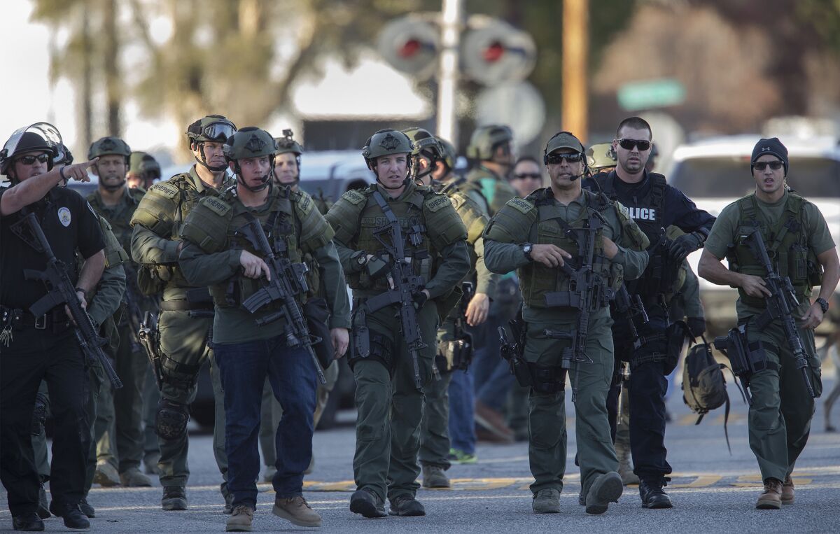 SWAT officers search for suspects in the San Bernardino mass shooting in the sort of image that is becoming commonplace on our televisions.