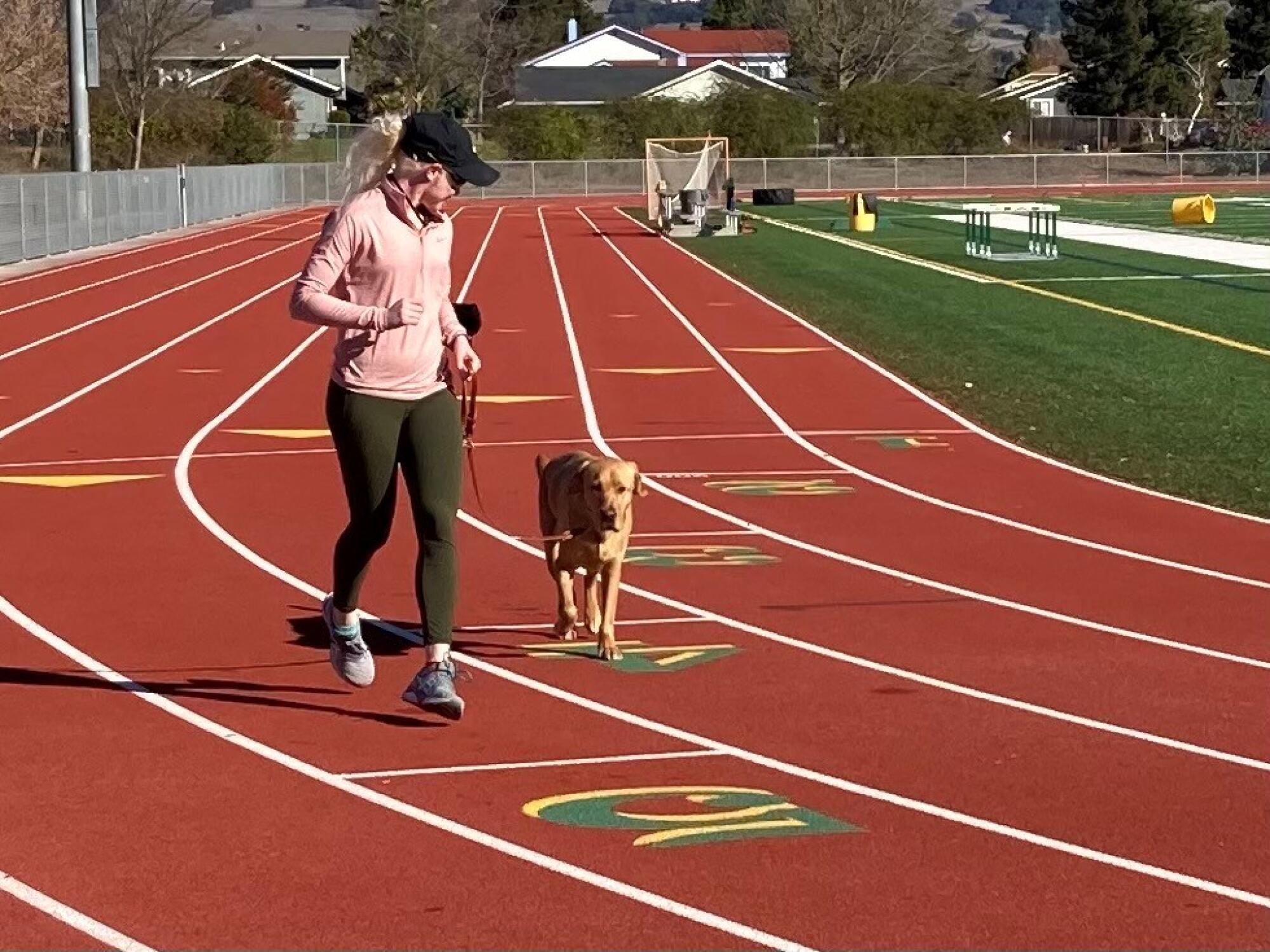 Kim Crosby and guide dog Tron have a routine at the track.
