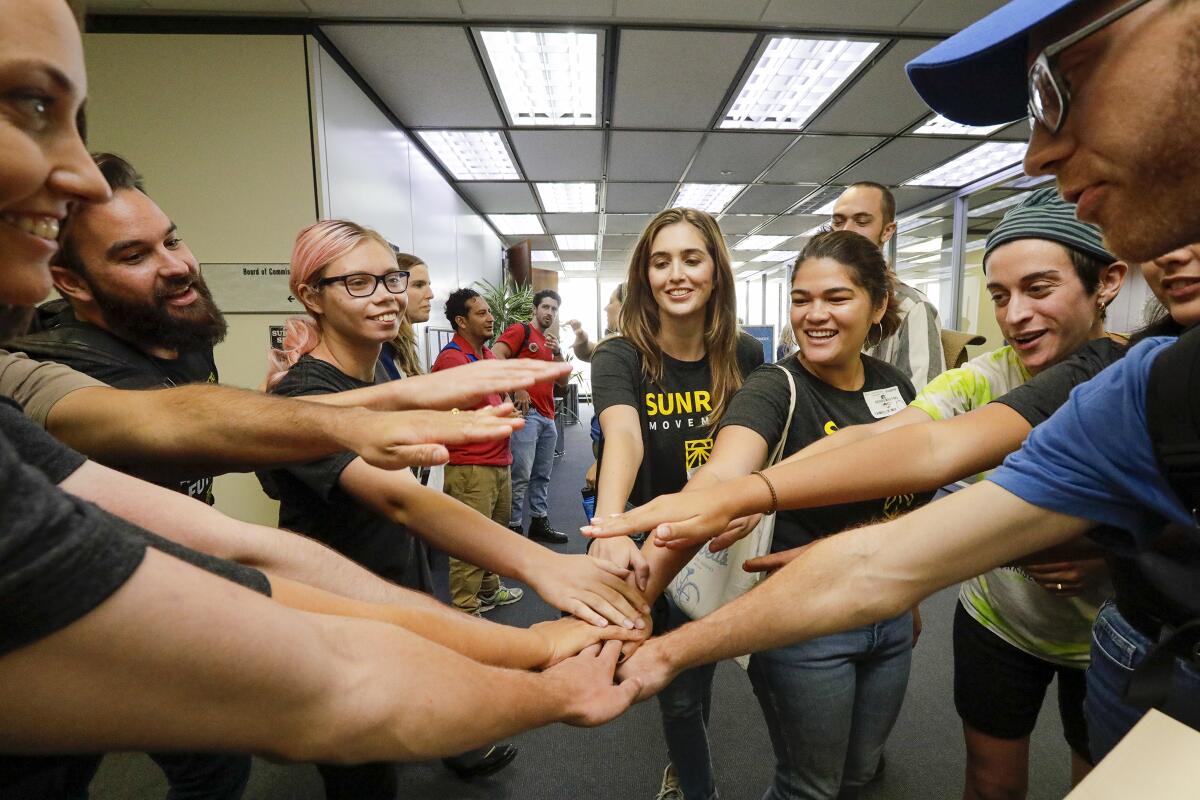 Environmental activists celebrate the Los Angeles Department of Water and Power board’s unanimous approval of a 25-year contract to buy energy from a solar project in Kern County. The Eland project set a record for cheapest solar power and battery energy storage in the United States.