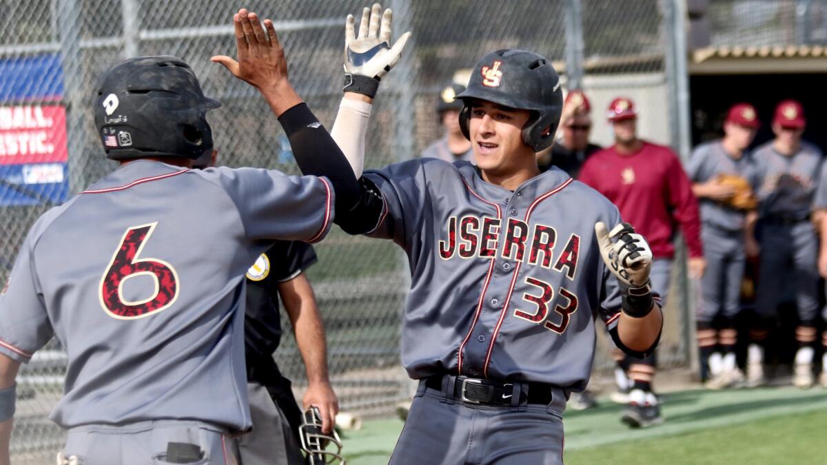 Chase Strumpf of JSerra is congratulated after hitting a two-run home run against St. John Bosco on Tuesday.