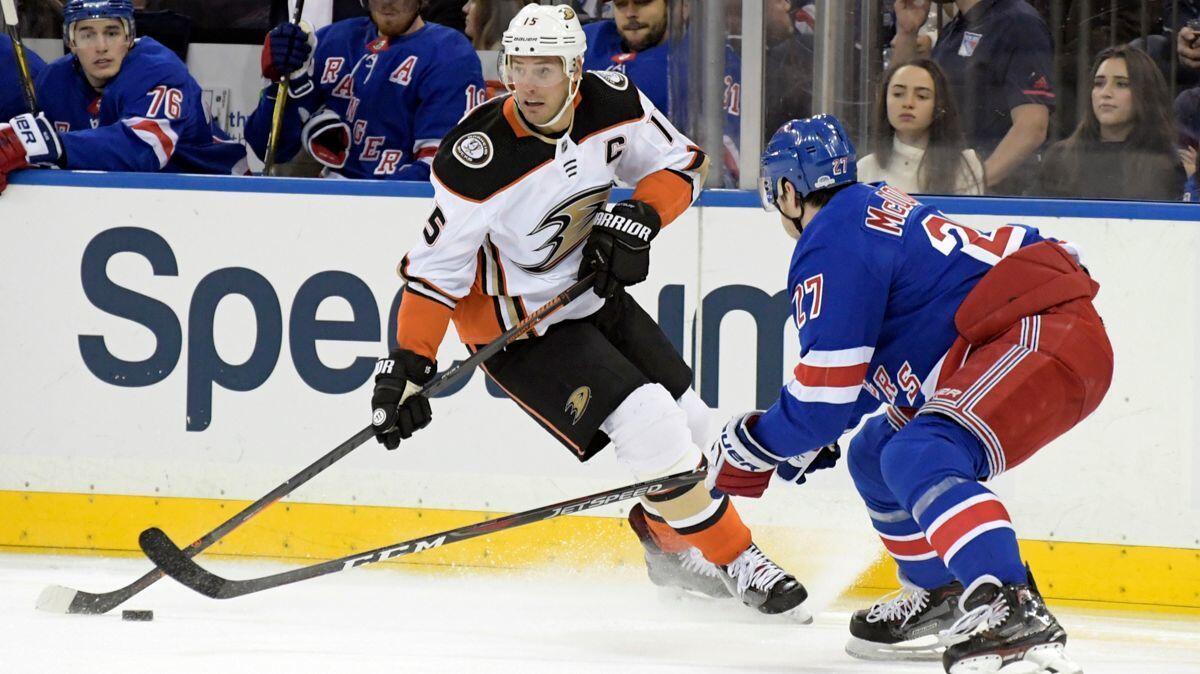 Anaheim Ducks center Ryan Getzlaf (15) and New York Rangers defenseman Ryan McDonagh (27) vie for the puck during the first period on Tuesday.
