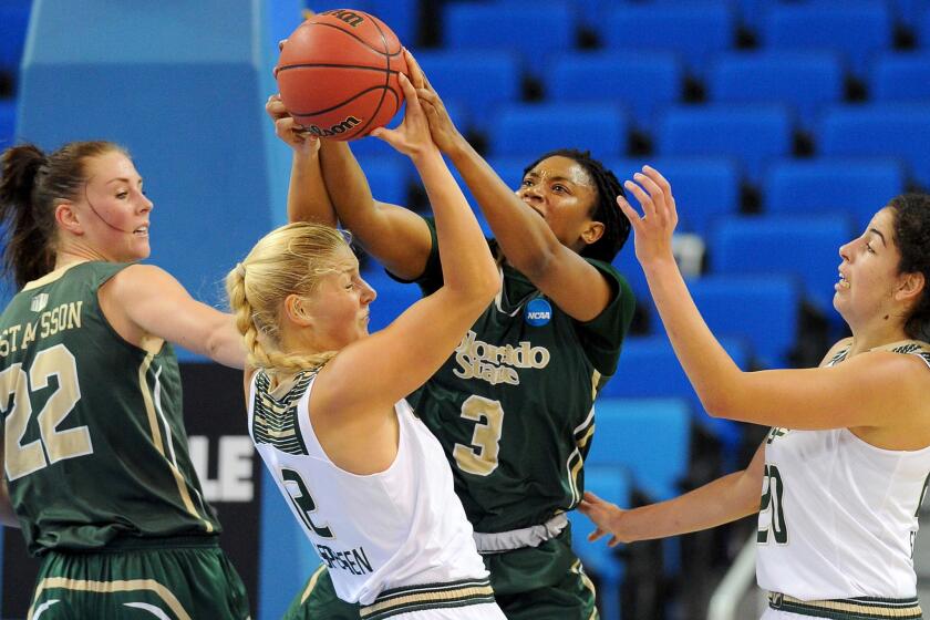 Colorado State's Keyora Wharry (3) and South Florida's Maria Jespersen, center, battle for a rebound during an NCAA tournament game on March 19.