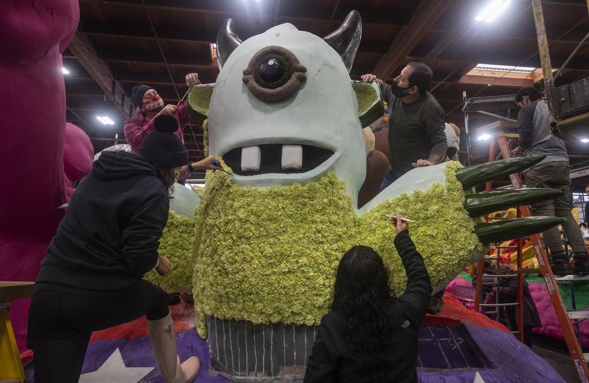 Volunteers apply carnations and tea leaves to The Monster. 