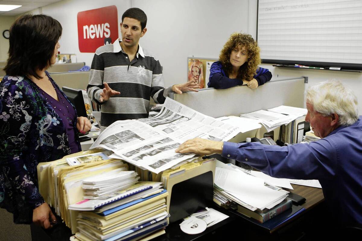 Alan Smolinisky, center, talks with Palisadian-Post publisher Roberta Donohue, left, staff writer Laurie Rosenthal and managing editor Bill Bruns while visiting the Pacific Palisades office.