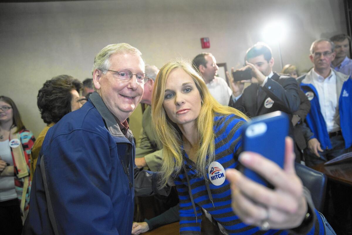 U.S. Sen. Mitch McConnell (R-Ky.) takes a photo with a supporter in Lexington.