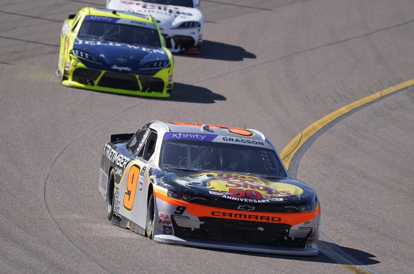 Noah Gragson (9) holds onto second early in a NASCAR Xfinity Cup Series auto race at Phoenix Raceway, Saturday, March 12, 2022, in Avondale, Ariz. (AP Photo/Darryl Webb)