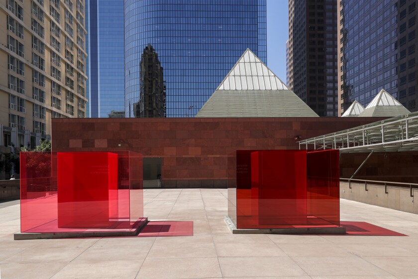 Red transparent cubes, an art installation by Larry Bell, sit outside the Museum of Contemporary Art in L.A.