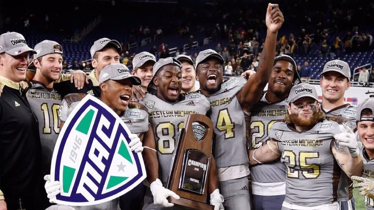Members of the Western Michigan football team celebrate after a victory over Ohio, 29-23, in the MAC title game on Dec. 2.