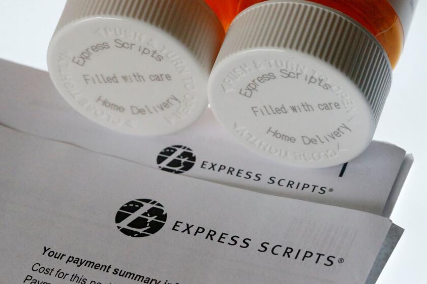 FILE - In this July 25, 2017, file photo, Express Scripts prescription medication bottles are arranged for a photo in Surfside, Fla. Health insurer Cigna will spend about $52 billion to acquire the pharmacy benefits manager Express Scripts, announced Thursday, March 8, 2018, the latest in a string of proposed buyouts and tie-ups in a rapidly shifting landscape for the health services industry. (AP Photo/Wilfredo Lee, File)