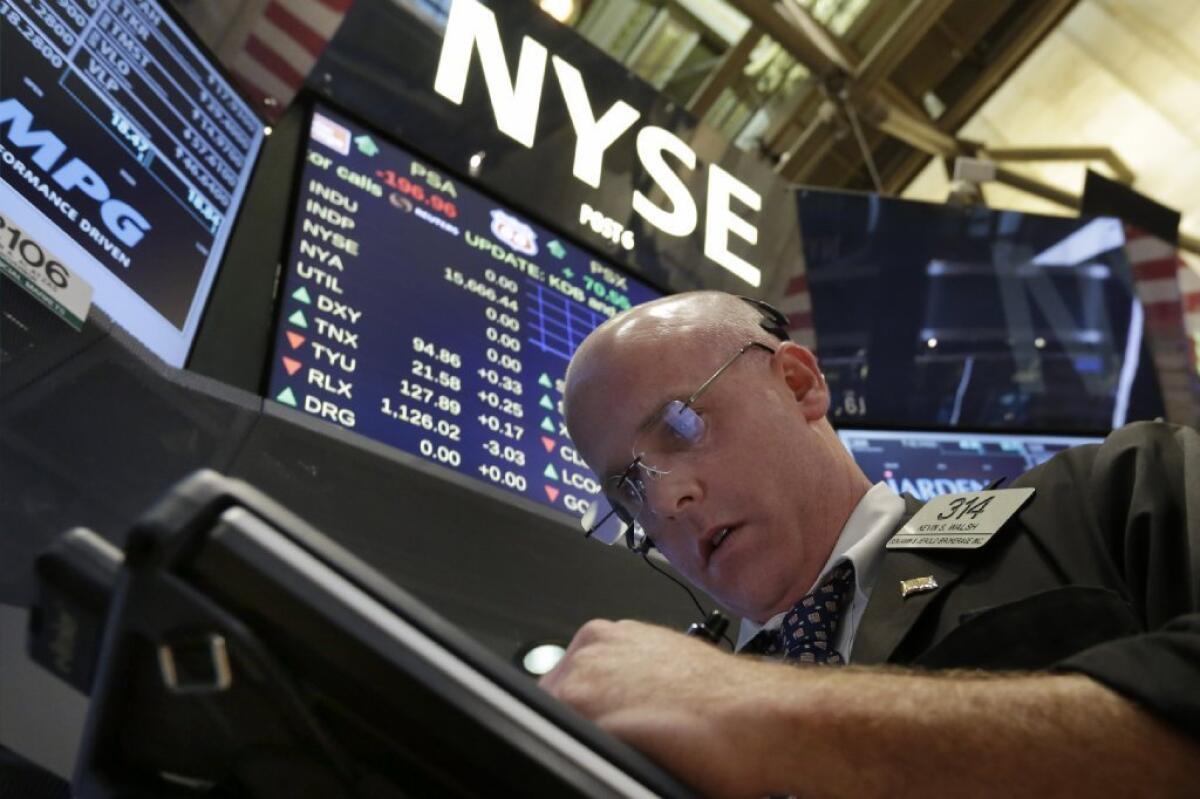 Trader Kevin Walsh works the floor of the New York Stock Exchange on Aug. 26.