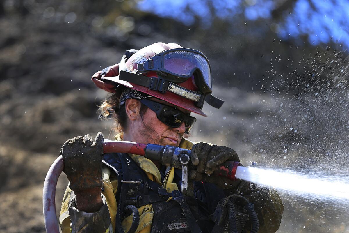 Cal Fire-San Diego firefighter Cpt. Angel Hendrie spends her 12th day on the road fighting fires and mopping up the remnants of the Sage fire in Santa Clarita.