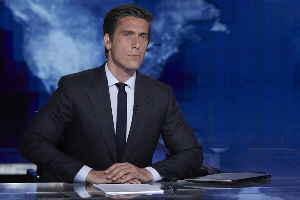 David Muir sits at the ABC News anchor desk.