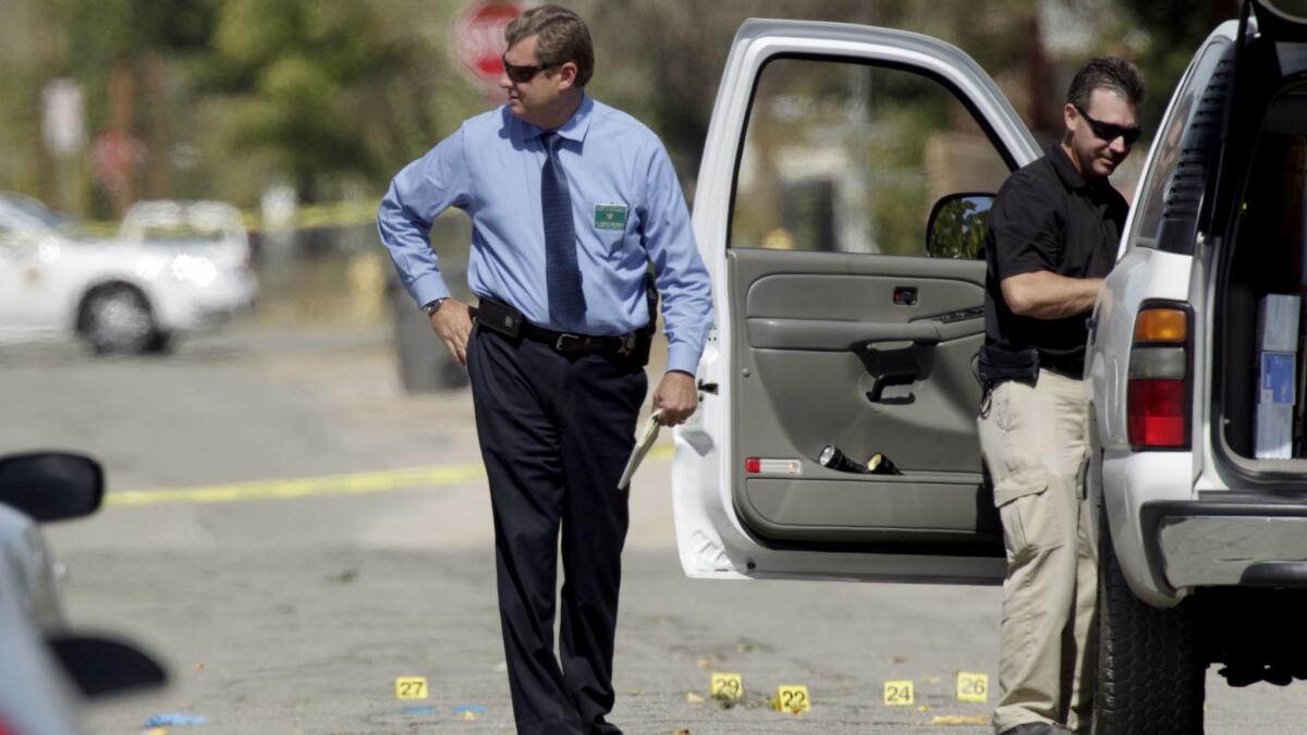 Homicide investigators search the scene of a double fatal shooting in Lancaster.