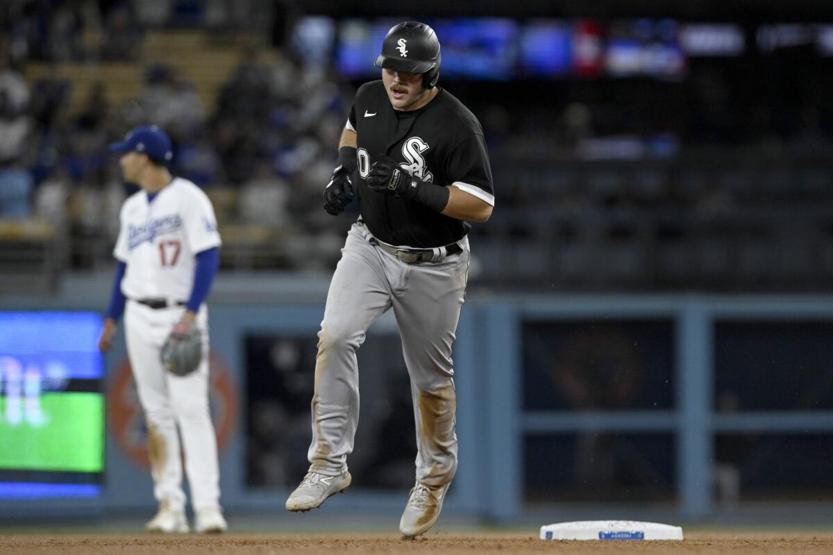 Chicago White Sox's Jake Burger rounds the bases after hitting a two-run home run against the Dodgers.