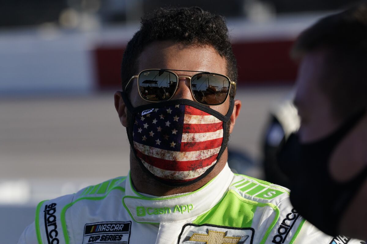 Bubba Wallace speaks to crew before a NASCAR Cup Series auto race Sunday, Sept. 6, 2020, in Darlington, S.C. (AP Photo/Chris Carlson)