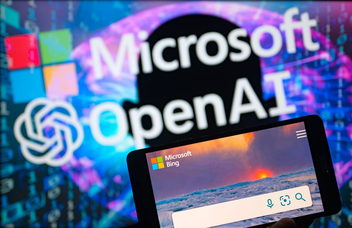 Microsoft and OpenAI seen on screen with Bing search engine app on mobile