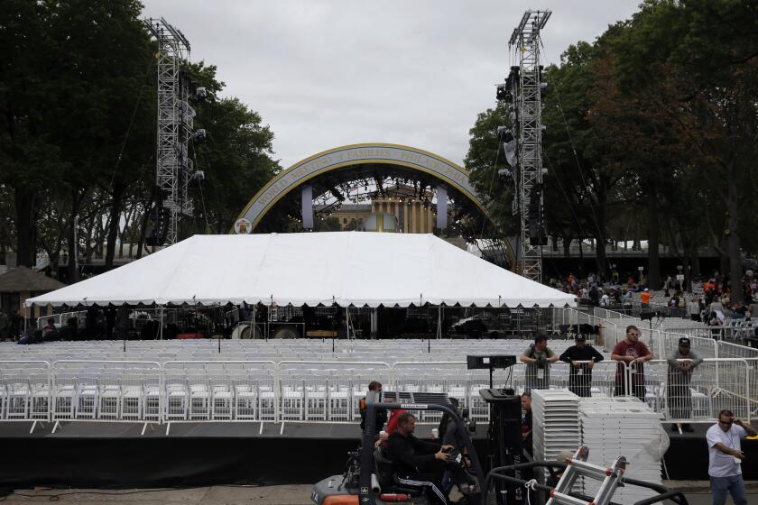 A tent blocks the view of the stage before a Mass by Pope Francis, causing the crowd gathered on the Benjamin Franklin Parkway to protest.