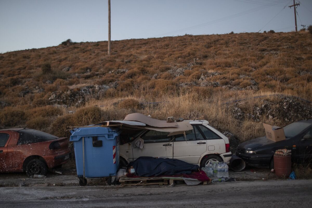 Migrants sleep on the roadside on the island of Lesbos, Greece.