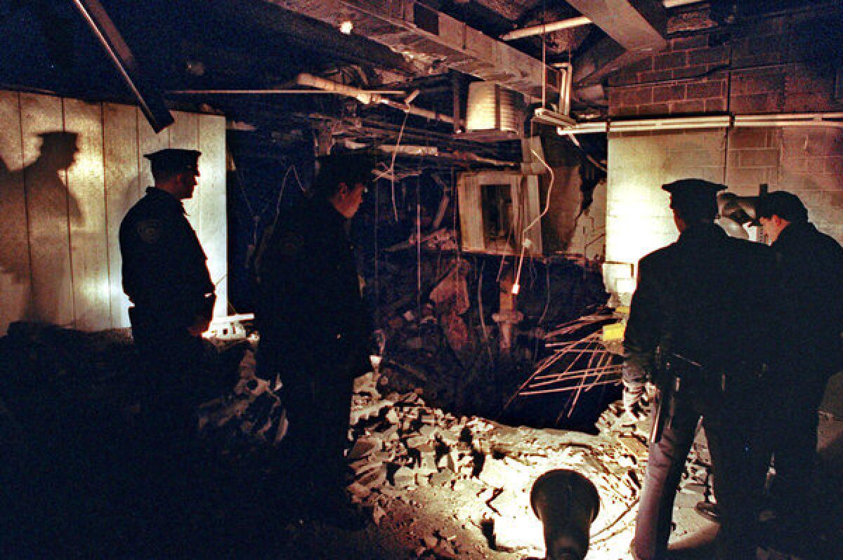 Port Authority and New York police view the damage a day after a truck bomb exploded in the garage of the World Trade Center.