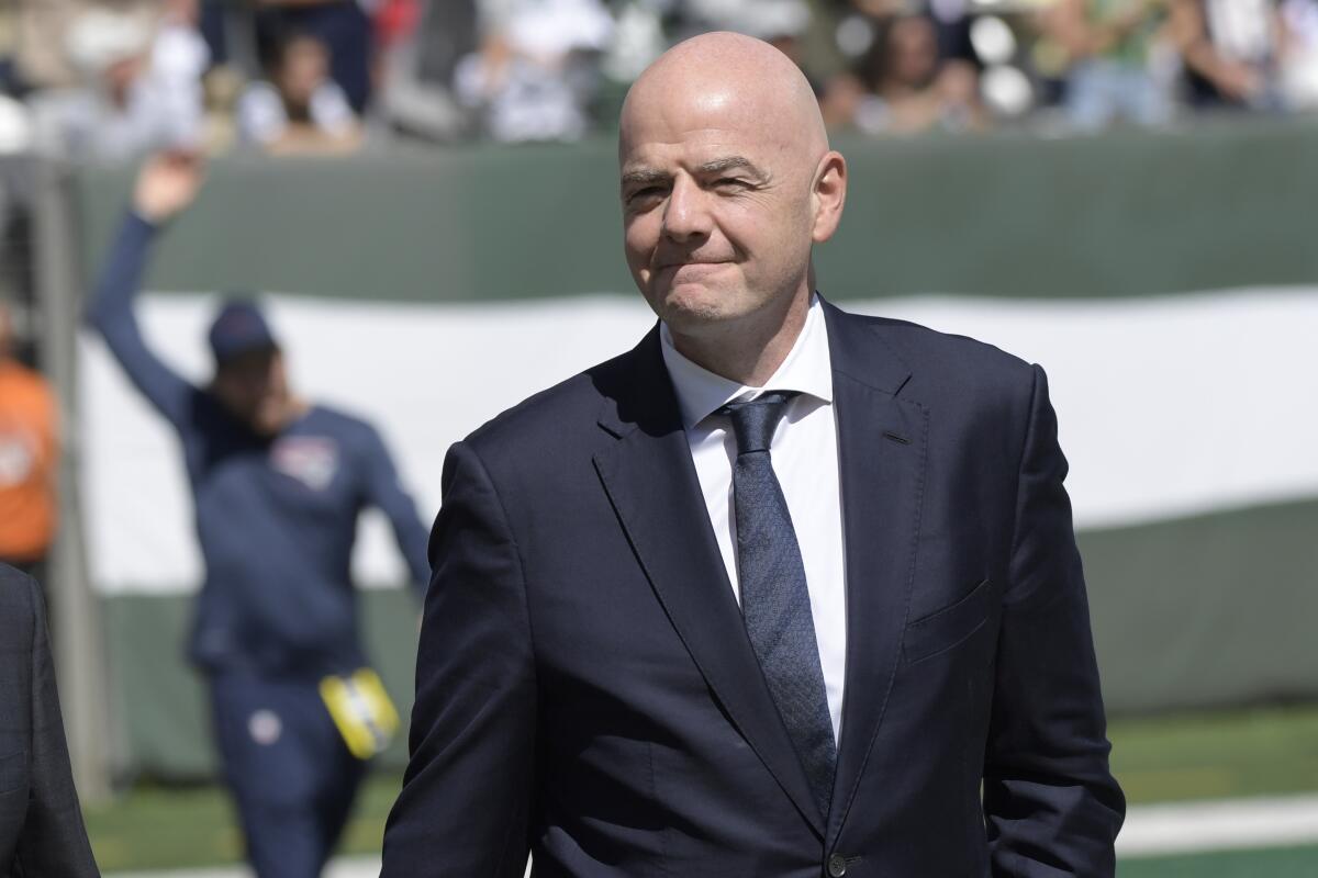 FIFA president Gianni Infantino walks on the field before  