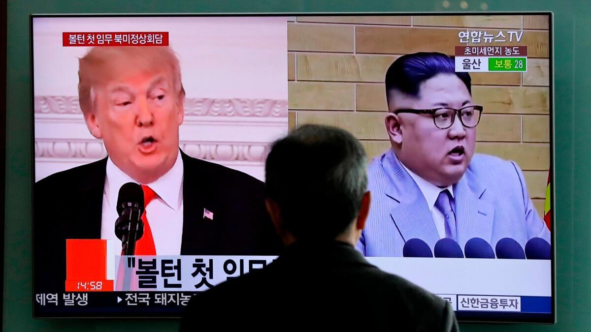 In this March 27 photo, a man watches a screen showing footage of President Trump and North Korean leader Kim Jong Un, in Seoul, South Korea.