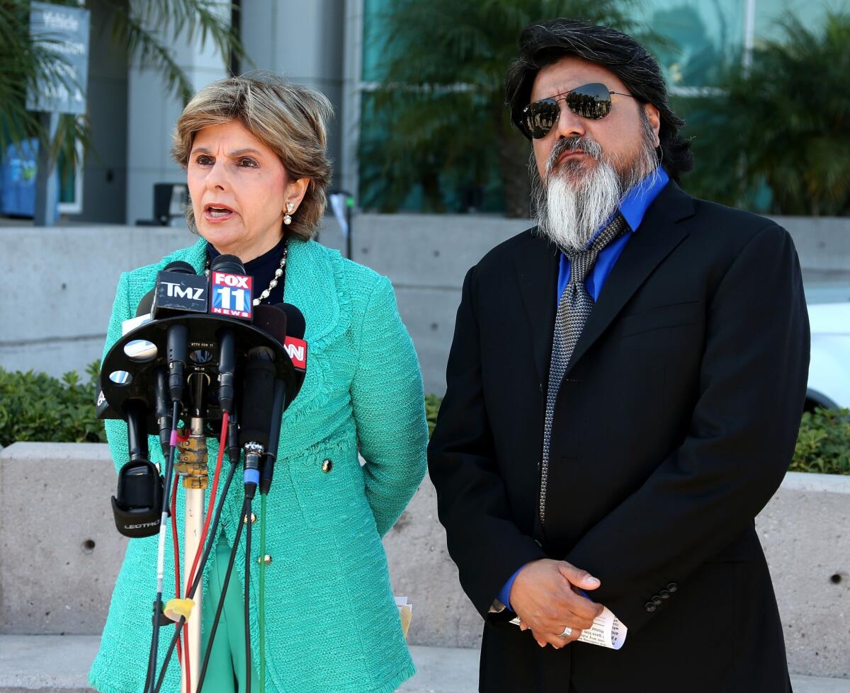 Attorney Gloria Allred and photographer Daniel Ramos speak during a news conference outside Superior Court in Los Angeles on Monday.
