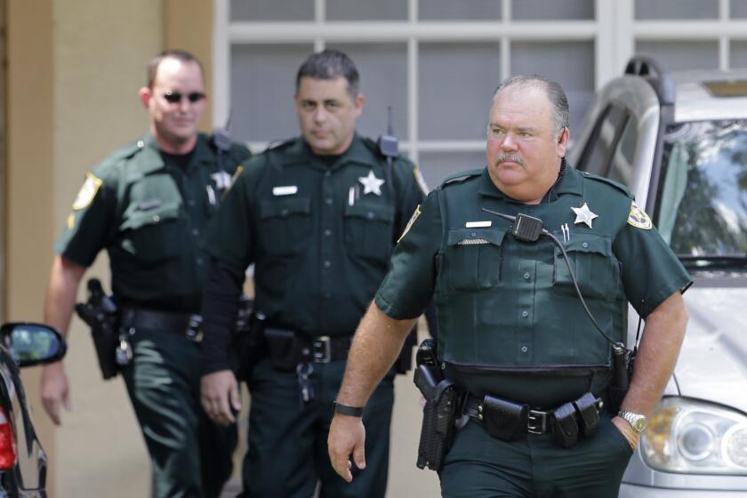 Port St. Lucie County sheriff's officers leave the Fort Pierce, Fla., property owned by the family of Seddique Mateen, the father of Pulse nightclub shooter Omar Mateen.
