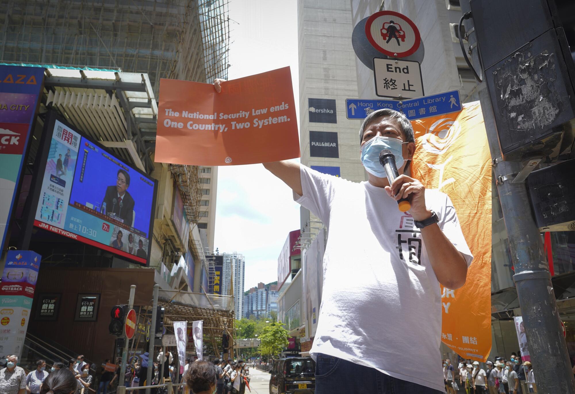 Activist Lee Cheuk-yan participates in a demonstration in Causeway Bay before the annual July 1 handover march in Hong Kong.