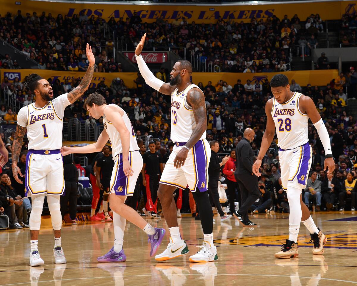 D'Angelo Russell high-fives LeBron James.